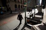 A pedestrian walks along Wall Street near the New York Stock Exchange (NYSE) in New York, U.S..