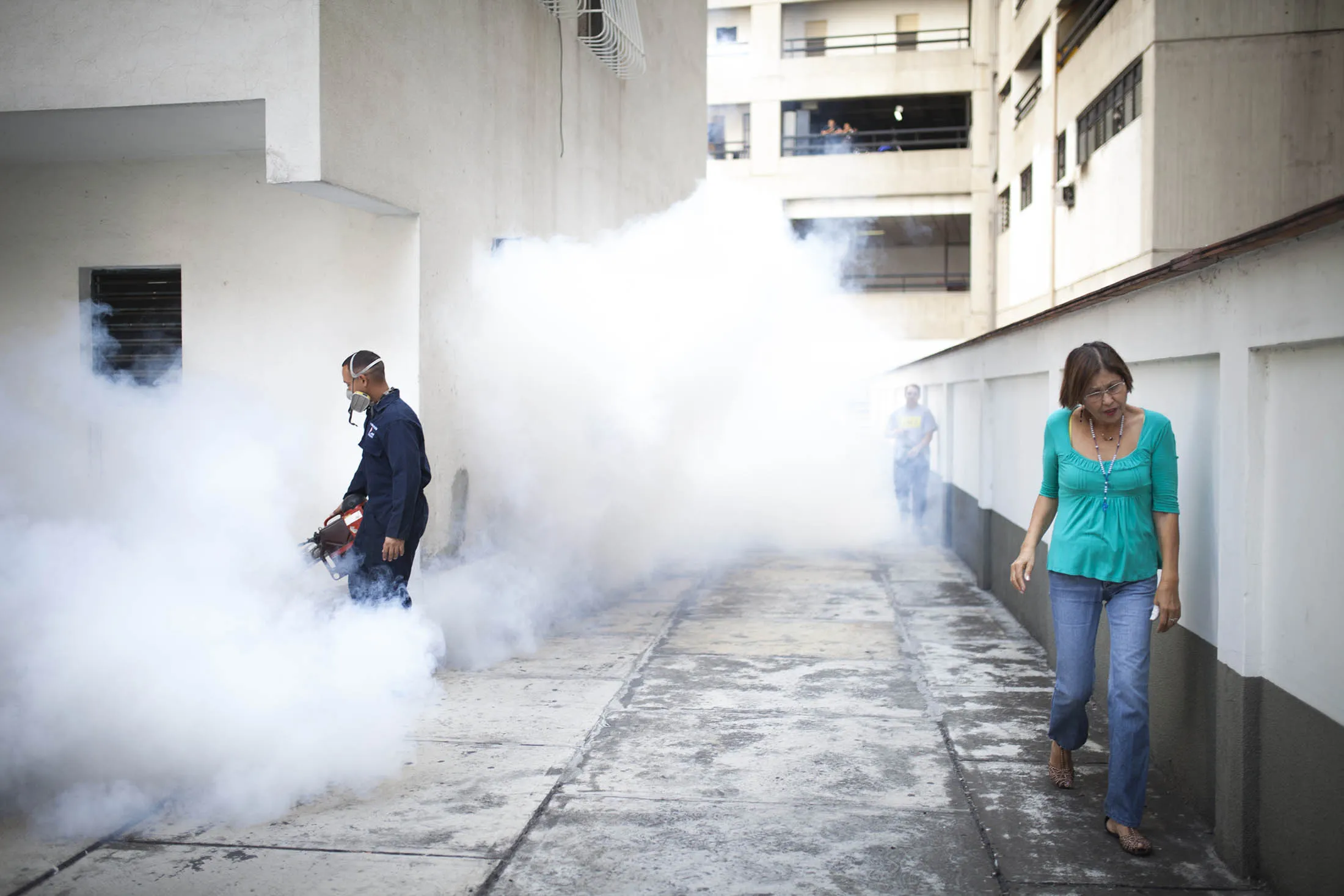 A worker from the Chacao municipality fumigates an apartment complex to eradicate mosquitoes that can spread the Zika virus in Caracas, Venezuela.
