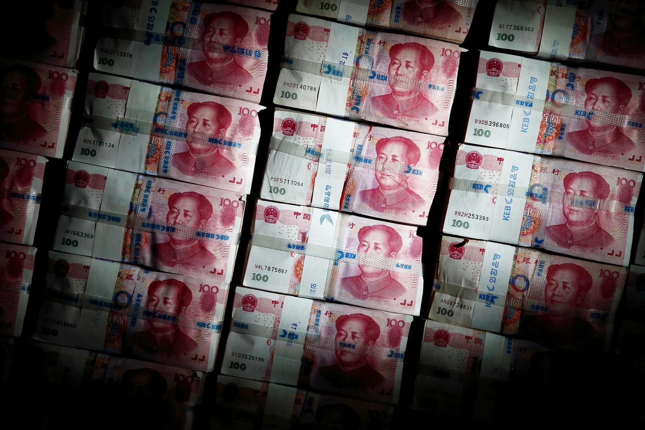 Chinese one-hundred yuan banknotes are stacked for a photograph at the Korea Exchange Bank headquarters in Seoul, South Korea, on Thursday, Feb. 27, 2014.
