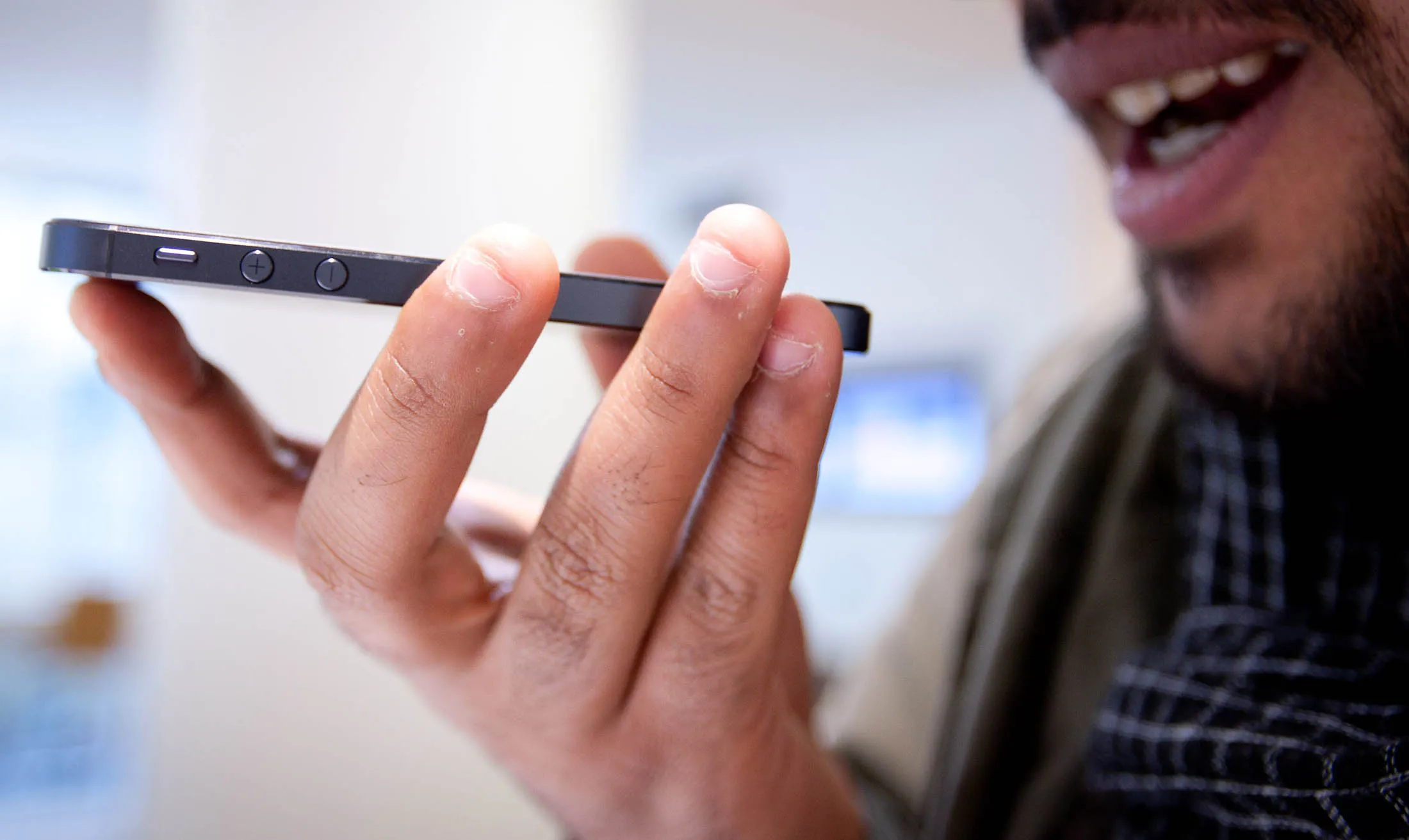 A customer uses the new iPhone 5 Siri function at a Telstra store on George Street  in Sydney, Australia, on Friday, Sept. 21, 2012.