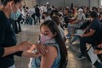 A healthcare worker administers a Covid-19 vaccine in Mexico City in July.