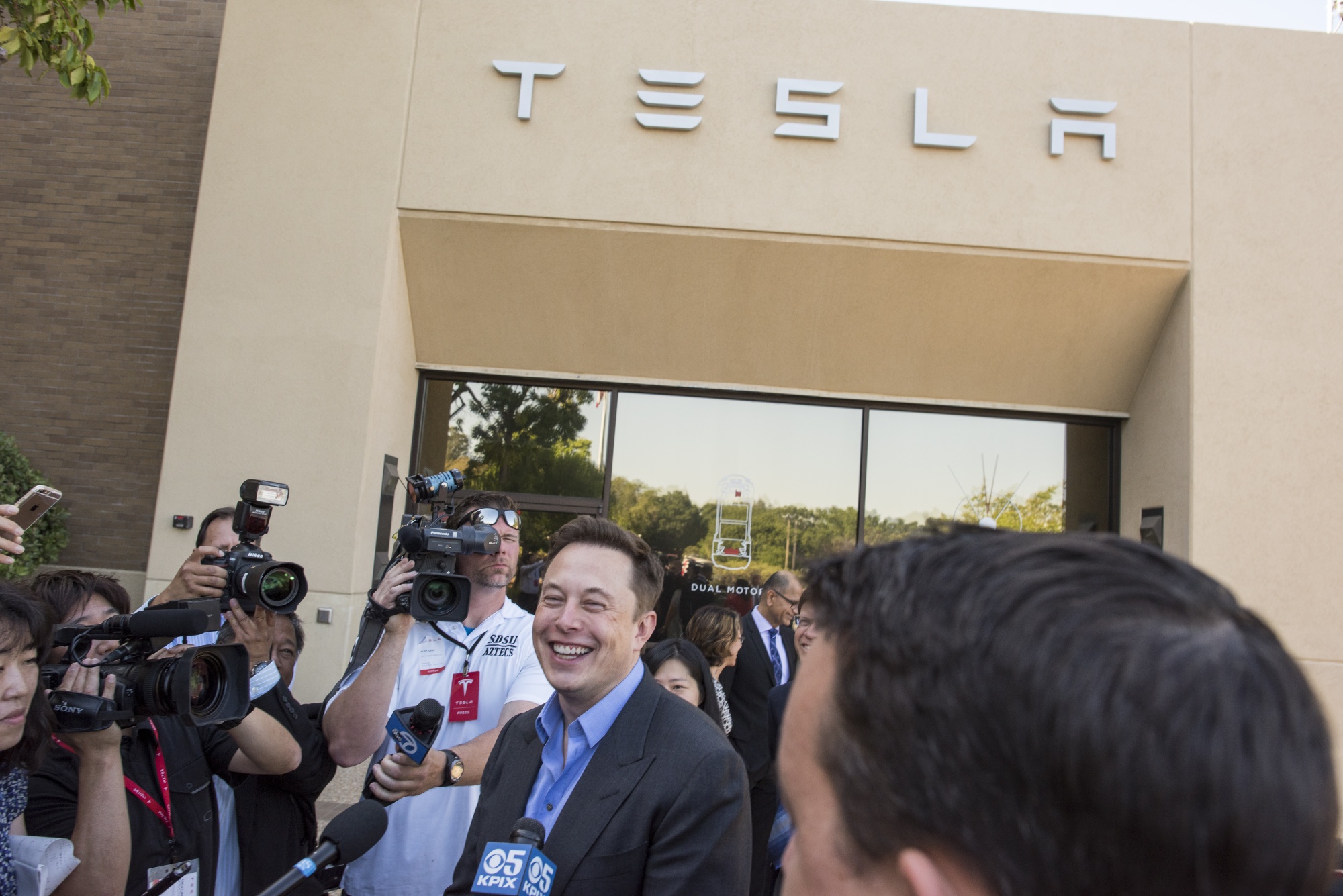 Elon Musk talks to reporters&nbsp;in front of Tesla headquarters in Palo Alto. Musk announced he’s moving the headquarters to Austin.&nbsp;