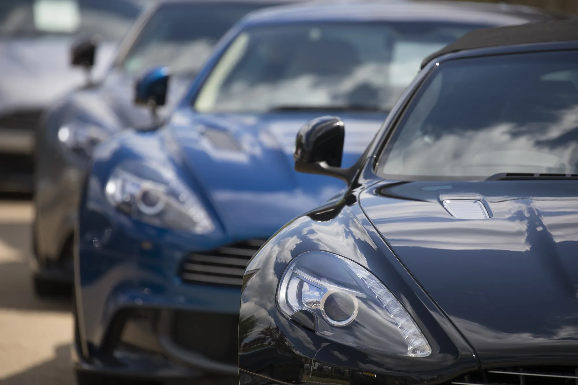 Luxury automobiles manufactured by Aston Martin Lagonda Global Holdings Plc at a dealership in Newport Pagnell, UK
