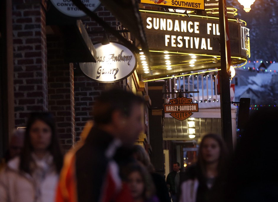 People walk past the Egyptian Theatre along Main Street before the opening day of the Sundance Film Festival in Park City, Utah.
