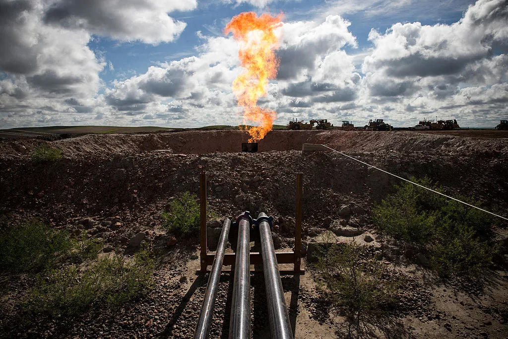 A gas flare is seen at an oil well site on July 26, 2013 outside Williston, North Dakota.&nbsp;