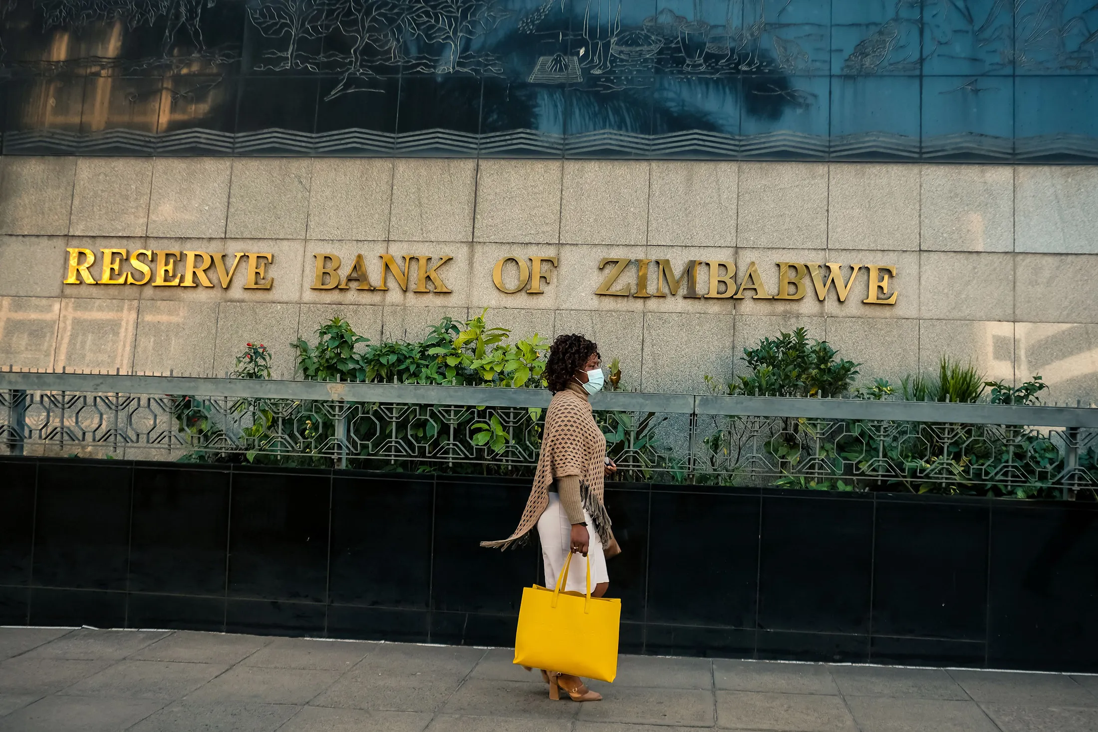 A pedestrian walks past the Zimbabwe Reserve Bank&nbsp;in Harare.