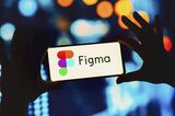 In this photo illustration, the Figma logo seen displayed on