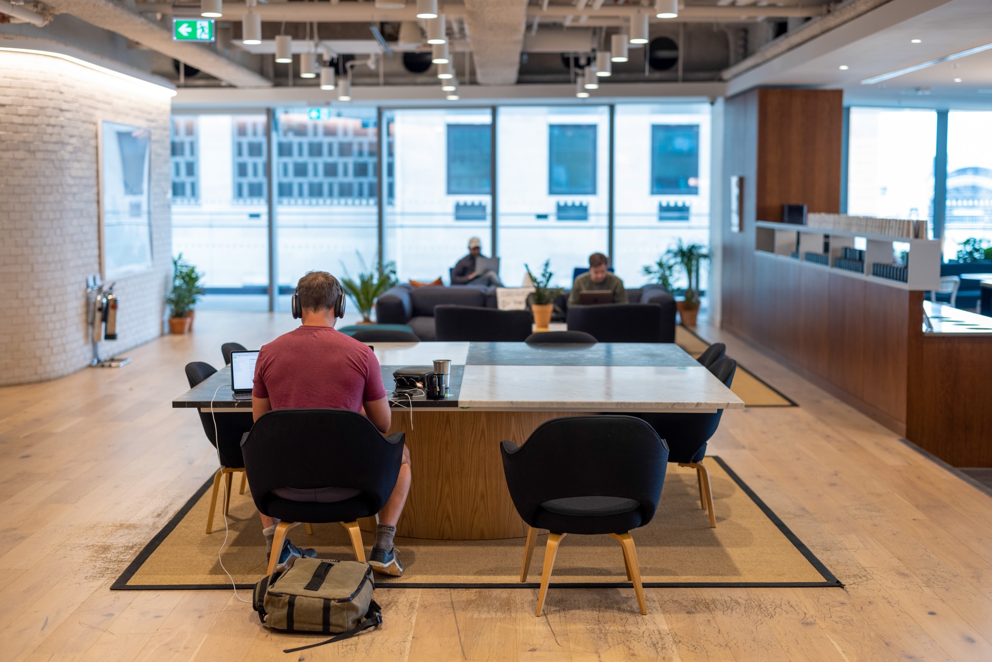 Office workers at desks in a co-working space.
