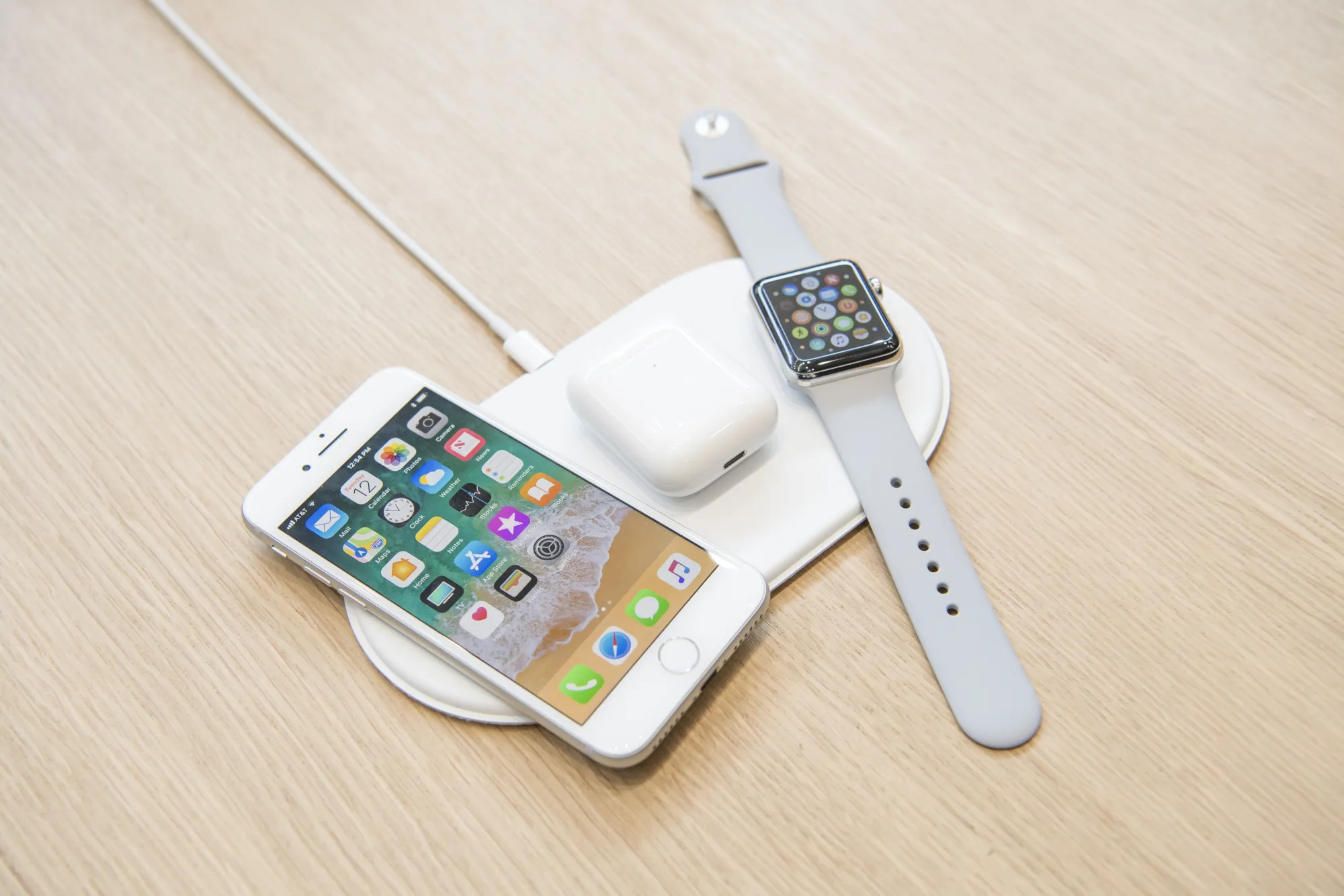 A iPhone,&nbsp;Airpods, and Apple Watch sit on the AirPower charger.