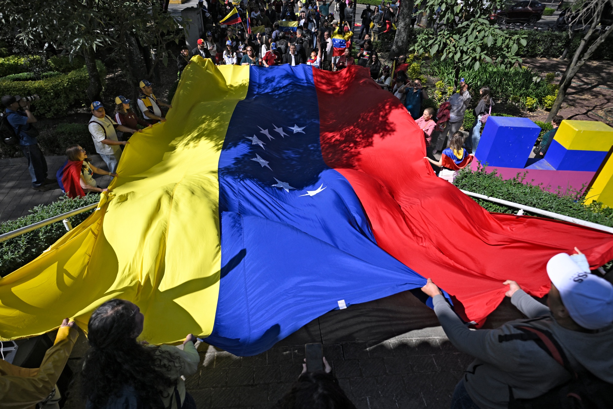 Venezuelans living in Mexico celebrate in Mexico City, on Jan. 4. Photographer: Alfredo Estrella/Getty Images