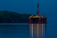 The Paul B. Loyd Jr drilling rig, operated by Transocean Inc., stands illuminated at night in the Port of Cromarty Firth in Cromarty, U.K.