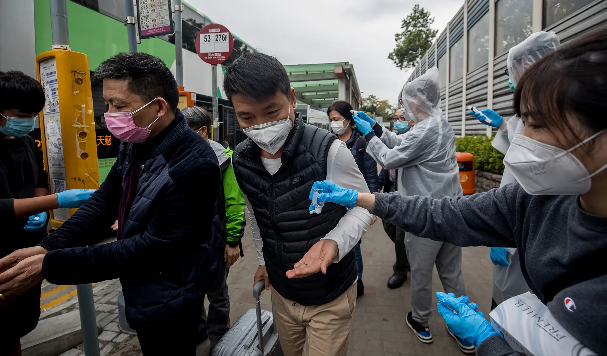 Volunteers pass out sanitizer at a civilian screening point in Hong Kong on Feb. 4. 