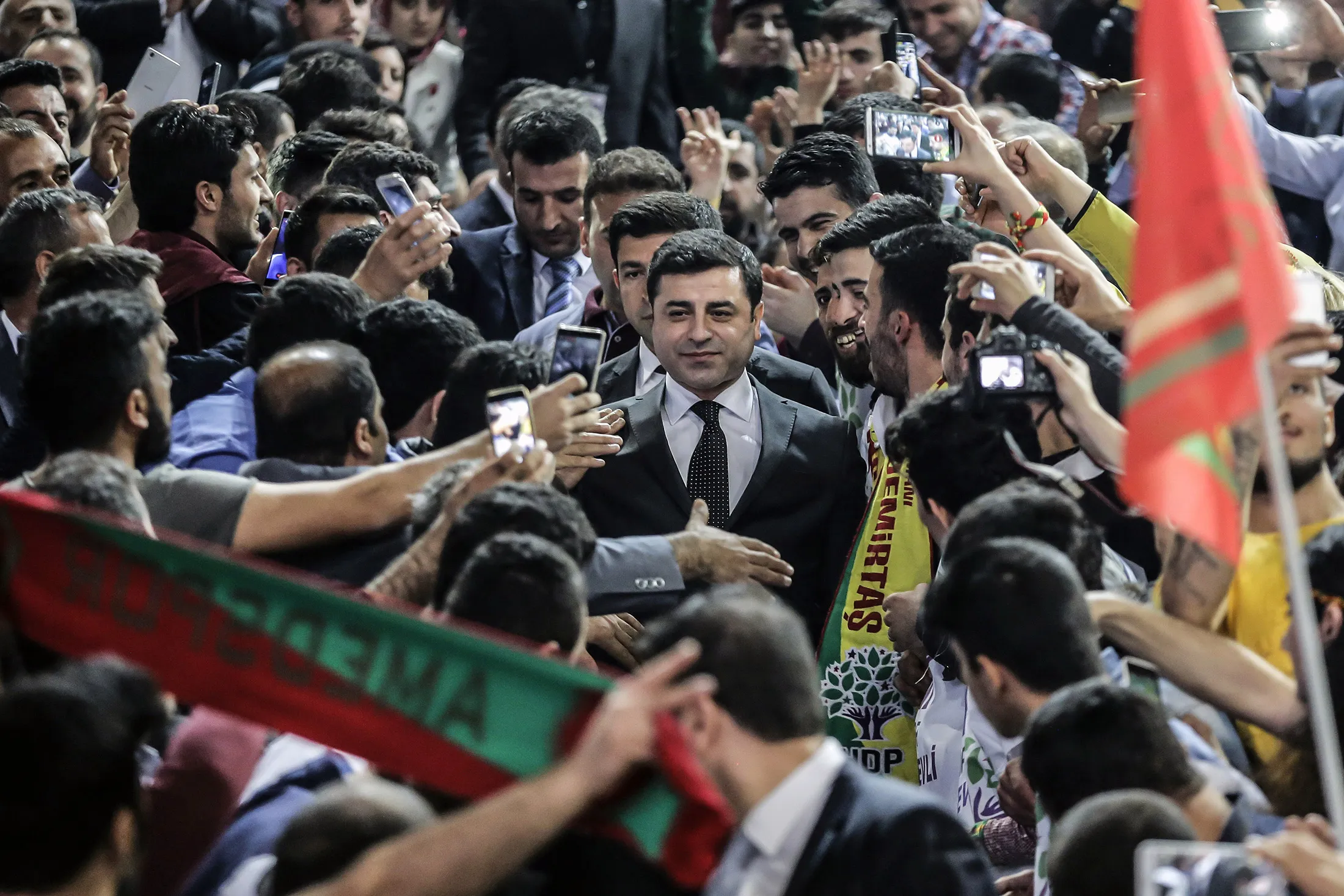 People cheer Co-leader of the pro-Kurdish Peoples' Democratic Party (HDP) Selahattin Demirtas, arriving for the first edition of the HDP provincial extraordinary congress in Istanbul on April 10, 2016.
