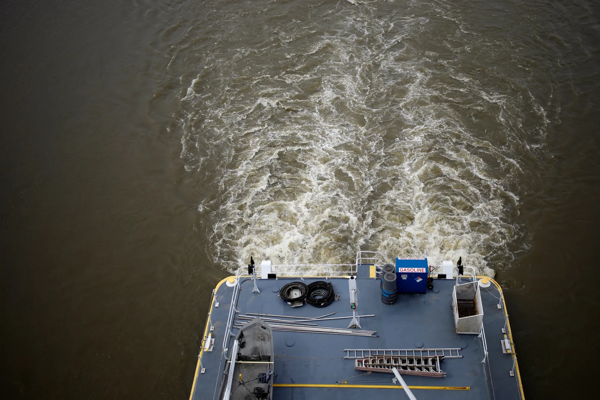 A towboat pushes barges up the Mississippi River in Granite City, Illinois.