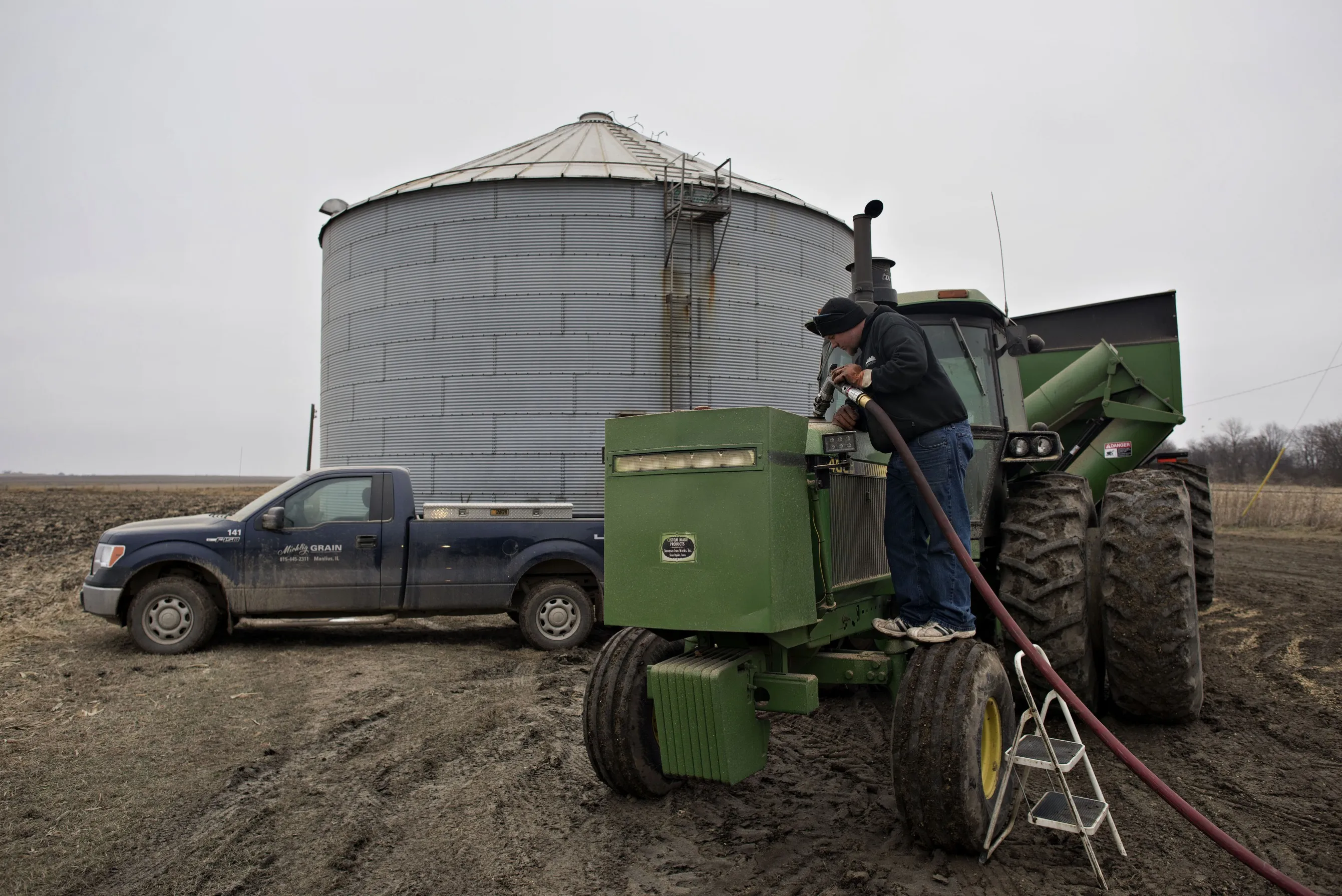 A worker delivers diesel fuel to a tractor in Manlius, Illinois.