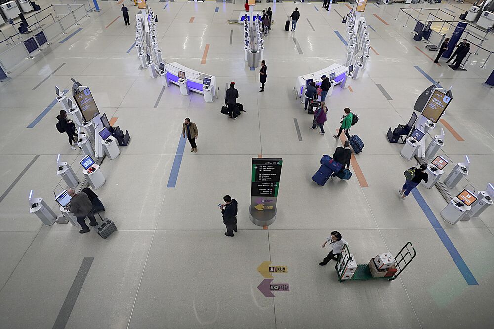 People check in at Terminal C at Logan International Airport in Boston on March 10, 2020.