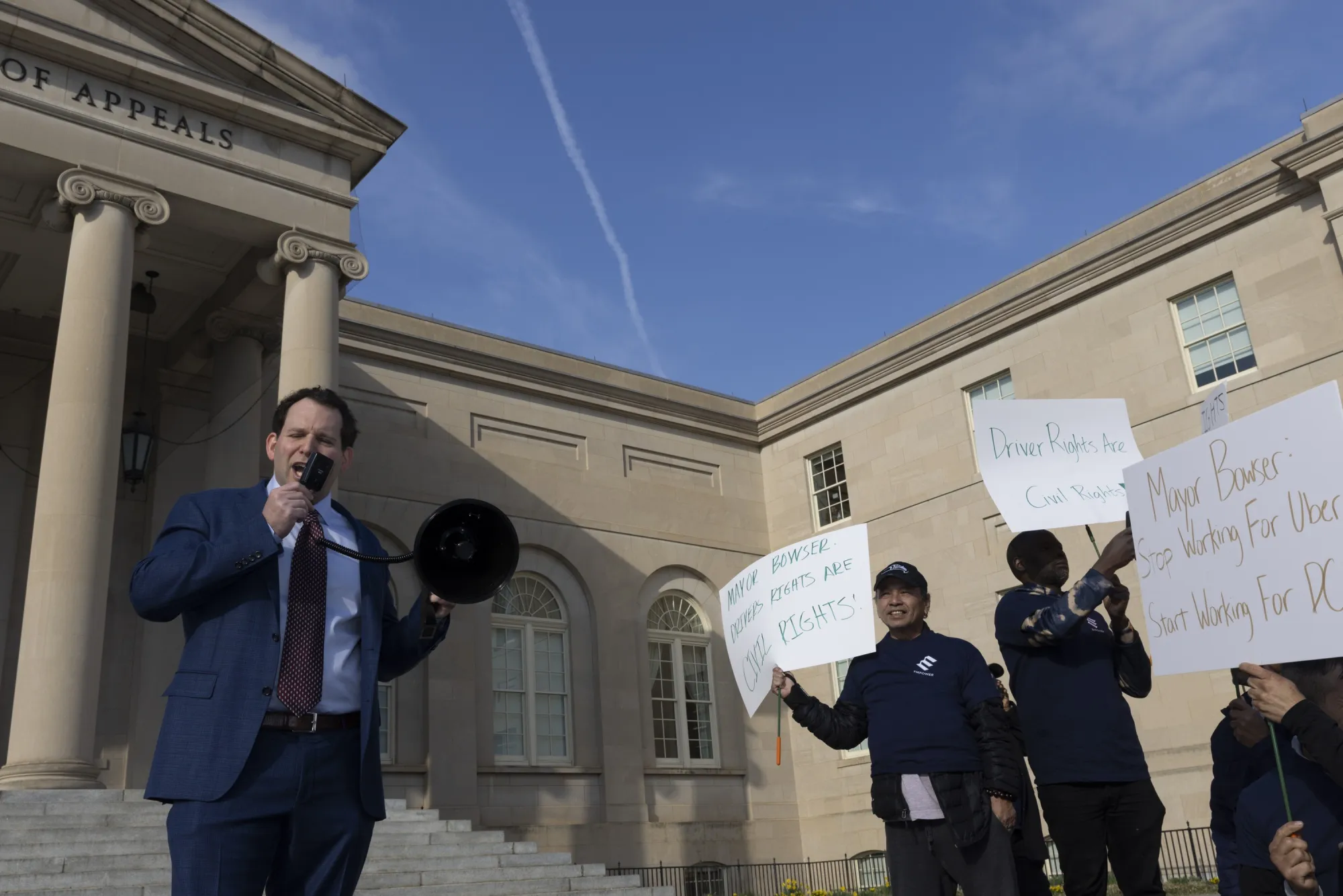Ridehail app&nbsp;Empower founder Joshua Sear, left, and Empower drivers in front of the District of Columbia Court of Appeals in Washington in 2025.