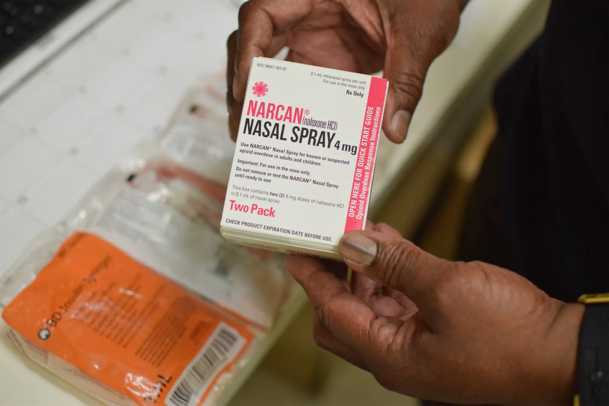 A program coordinator for the nonprofit Family and Medical Counseling Service Inc. holds a box of Narcan Nasal Spray in Seat Pleasant, Maryland, U.S., on Thursday, June 10, 2021.