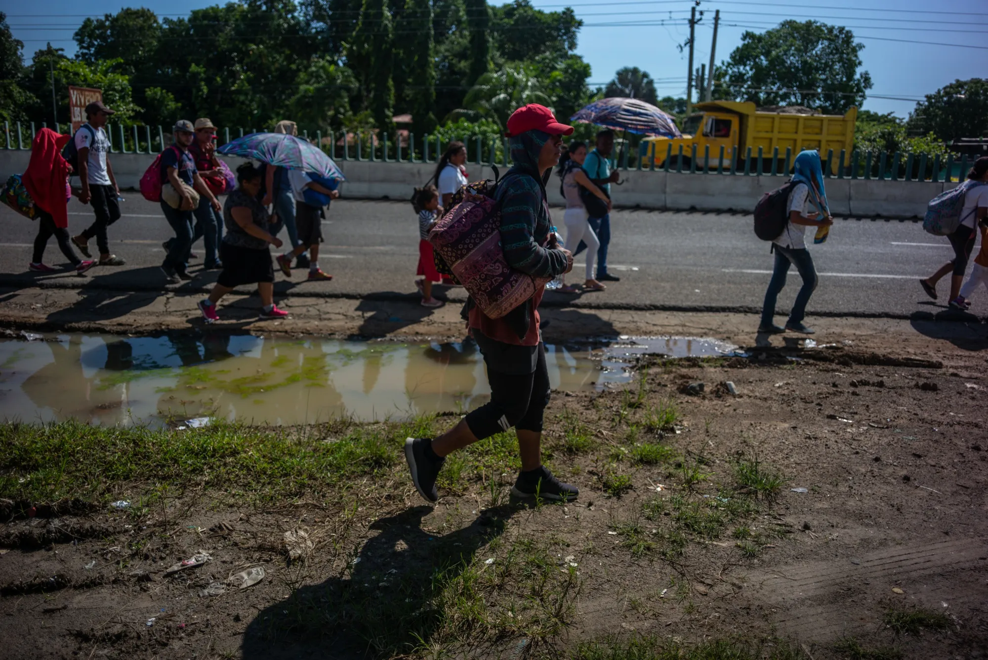 A group of Central American refugees and asylum seekers walk along a road in the town of Tapachula, Chiapas state, Mexico, on Monday, Oct. 22, 2018.