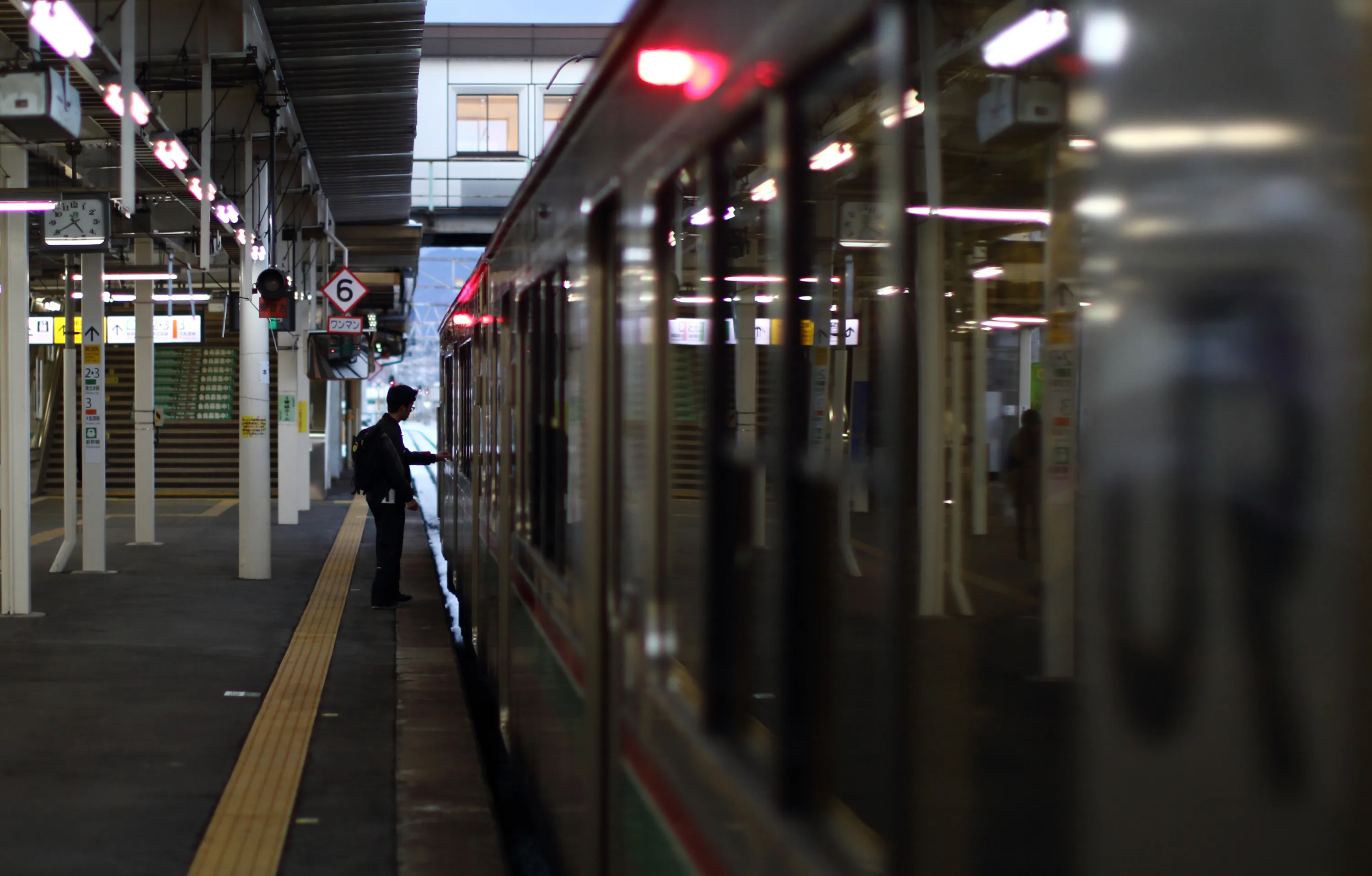 A passenger prepares to board a train at the Ichinoseki train station in Ichinoseki, Iwate prefecture, Japan, on Sunday, Jan. 18, 2015. Japan plans a record budget for next fiscal year to support an economy that fell into recession after Prime Minister Shinzo Abe's government increased the sales tax.