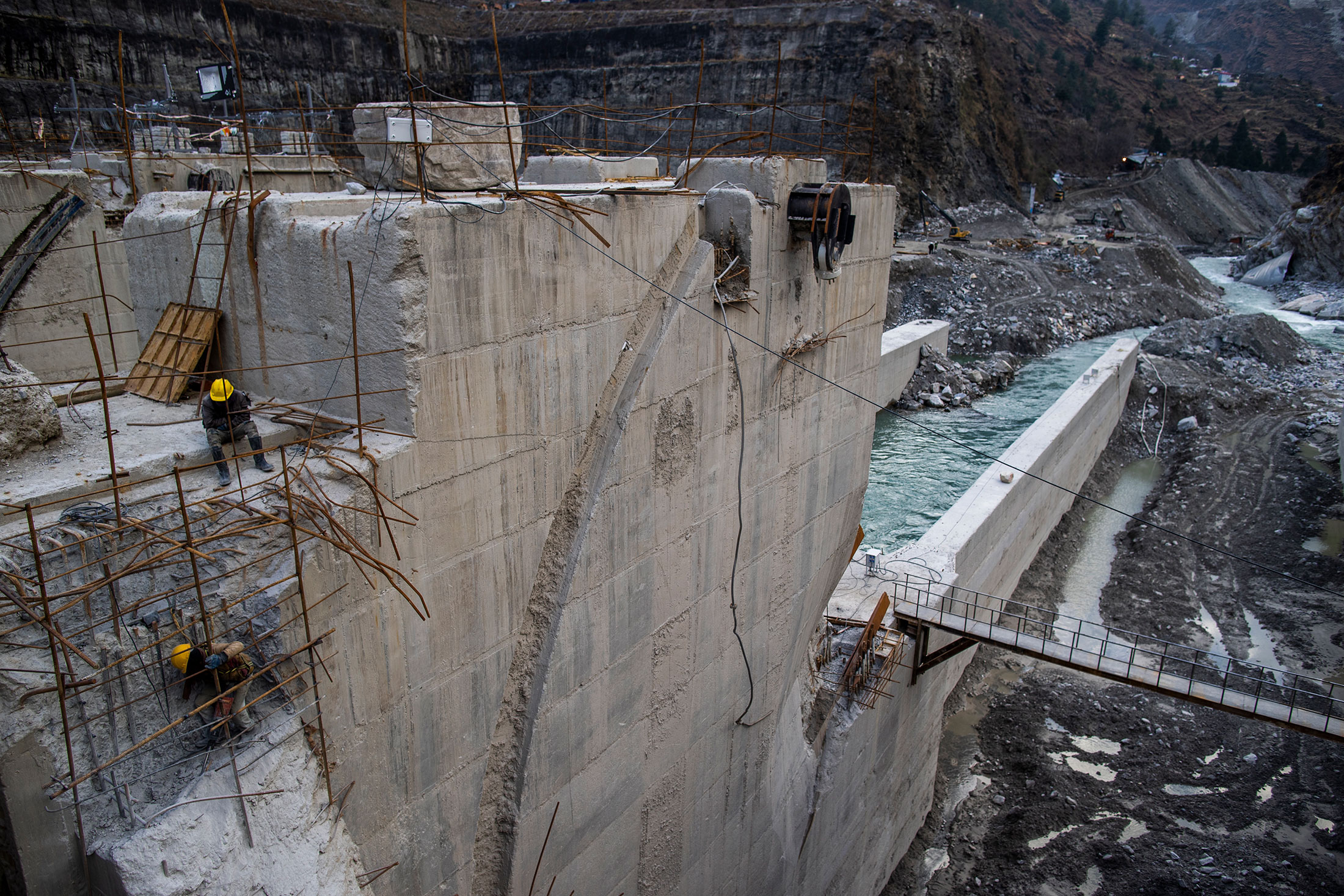 Workers repair the Tapovan Vishnugad plant following a deadly landslide in 2021