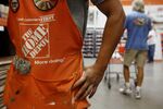 The Home Depot Inc. logo is seen on an employee's apron.