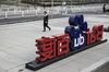 A man walks past a sign for Baidu Inc. at the entrance to the Baidu Technology Park in Beijing, China, on Friday, Nov. 25, 2016.