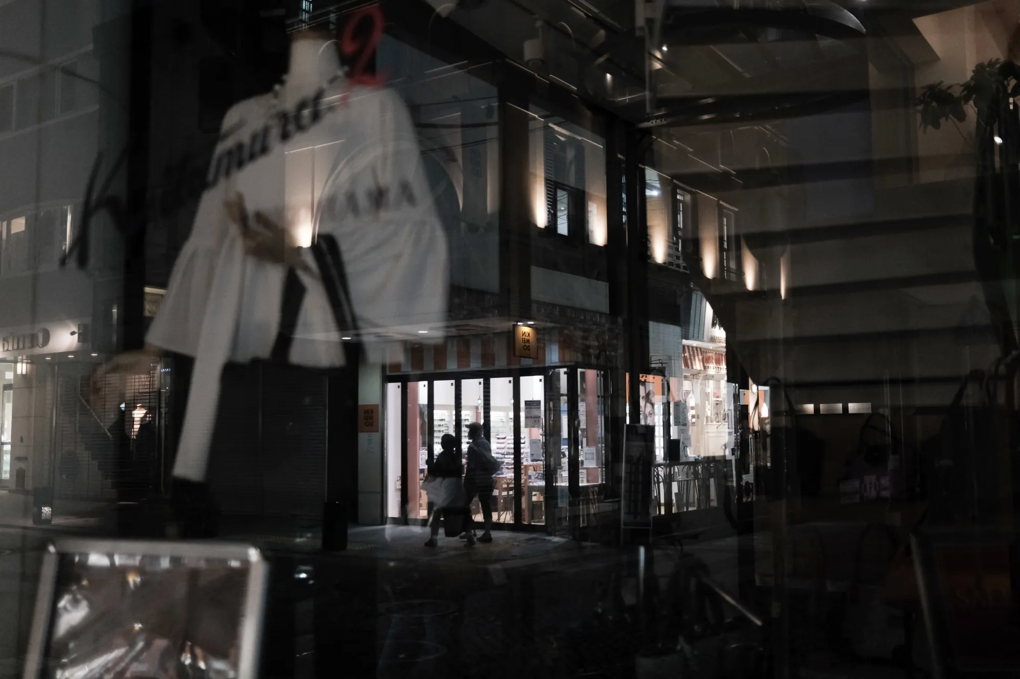 Pedestrians walk past a clothing store in Yokohama, Japan, on&nbsp;Sept. 16.