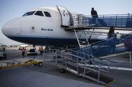 Travelers board a JetBlue Airways Corp. Airbus Group SE A320 aircraft on the tarmac at Long Beach Airport (LGB) in Long Beach, California, U.S., on Monday, April 25, 2016. JetBlue Airways Corp. is scheduled to release earnings figures on April 26. Photographer: Patrick T. Fallon/Bloomberg