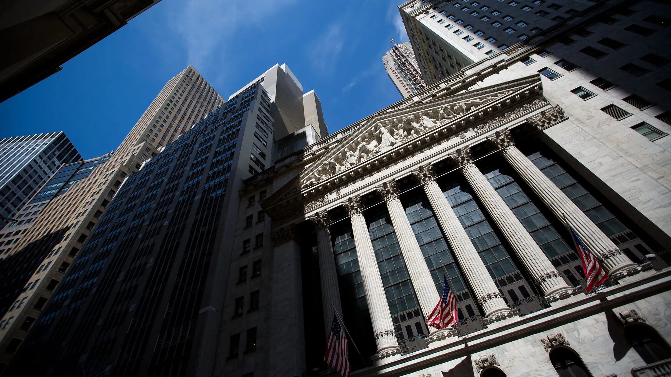 American flags fly outside of the New York Stock Exchange on June 2, 2017.

