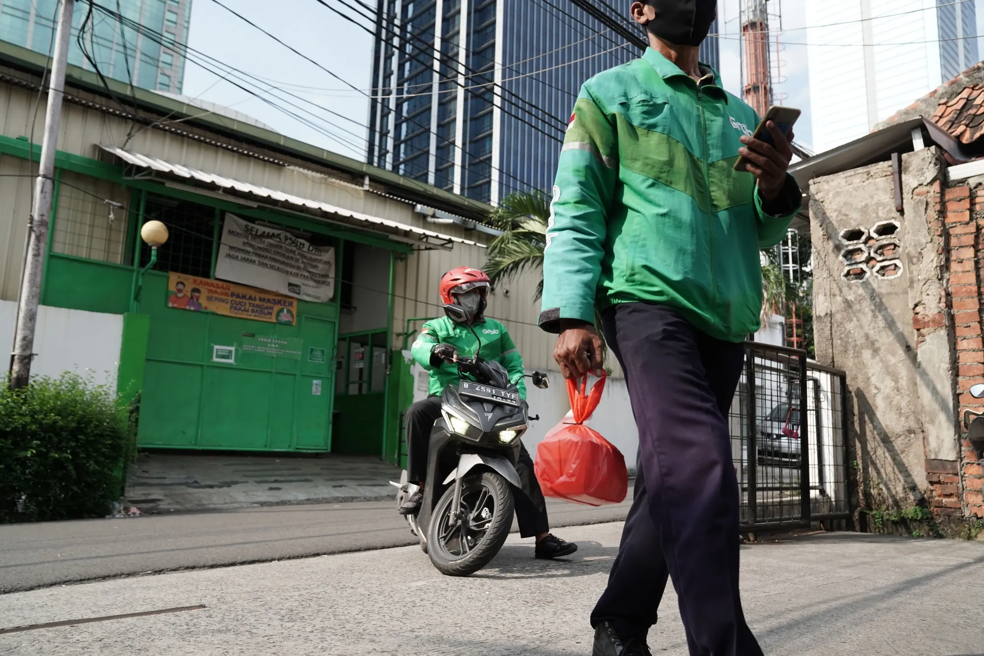 Drivers with GrabFood deliver food in Jakarta.