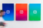 An employee walks past branded posters displayed at the Instagram Inc. office in New York, U.S., on Monday, June 4, 2018.