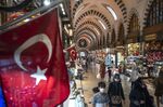 Tourists and locals shop inside a market in Istanbul, Turkey.