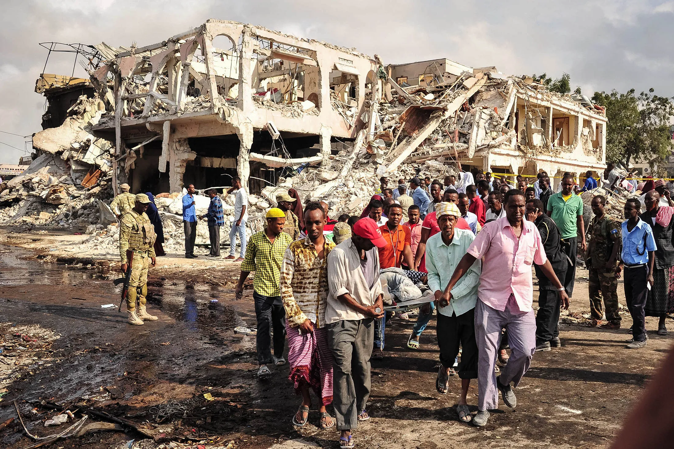 Somali men carry the body of a victim who died in the explosion of a truck bomb in the centre of Mogadishu, on Oct..15.
