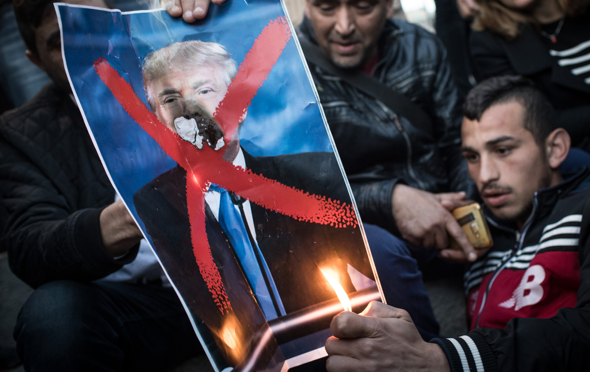 Protesters burn a poster of U.S. President Donald Trump in Jerusalem&nbsp;on Dec.&nbsp;11, 2017.