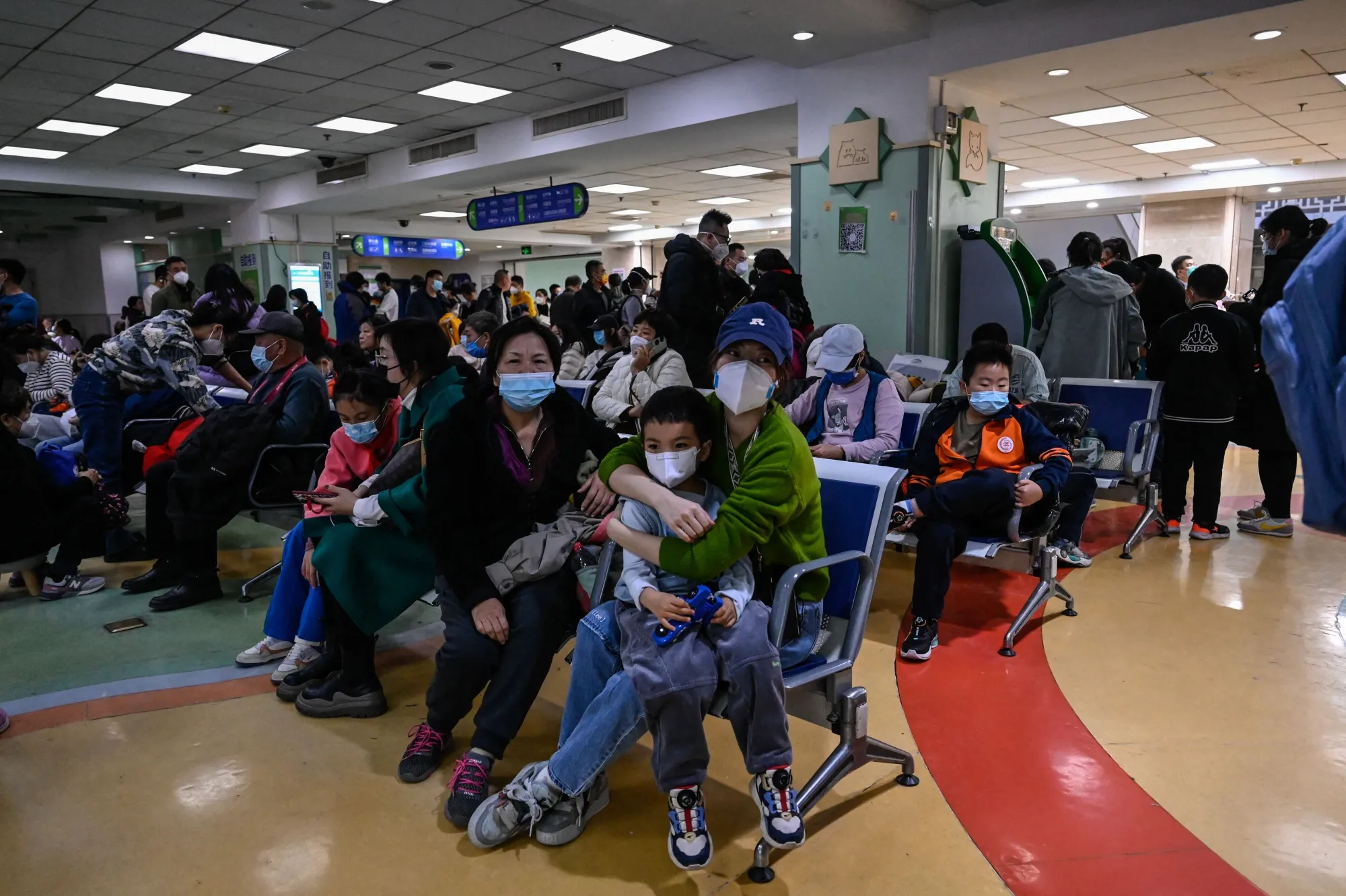 Children and their parents wait at an outpatient area at a children hospital in Beijing on Nov. 23.