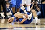 Florida Gators guard Scottie Wilbekin winces in pain after twisting his ankle during a NCAA basketball game in Storrs, Connecticut on Dec. 2, 2013