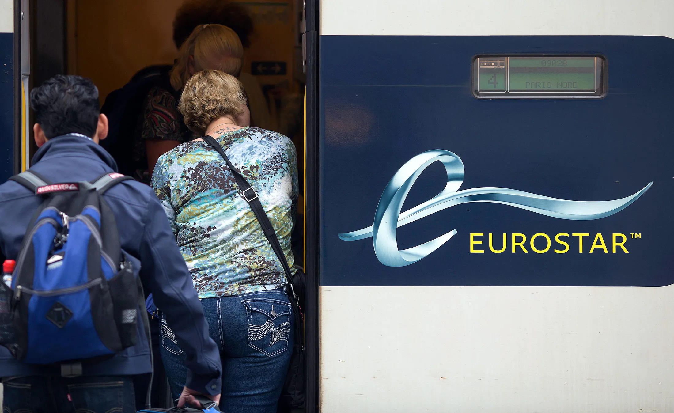 Passengers board a Eurostar train.
