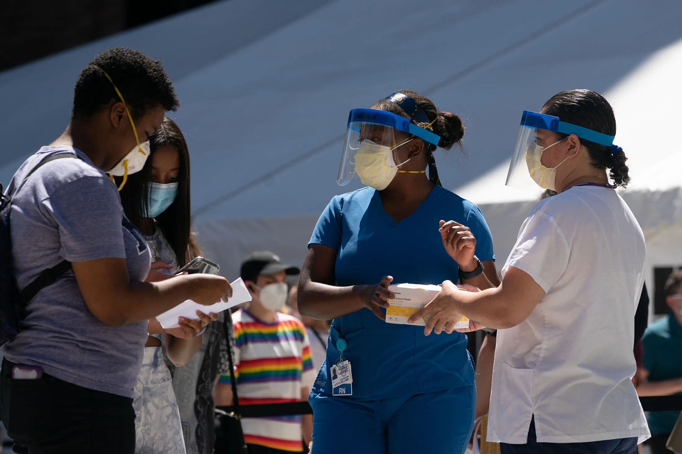 Medical workers speak to New York University students at a Covid-19 testing site in New York on Aug 18.