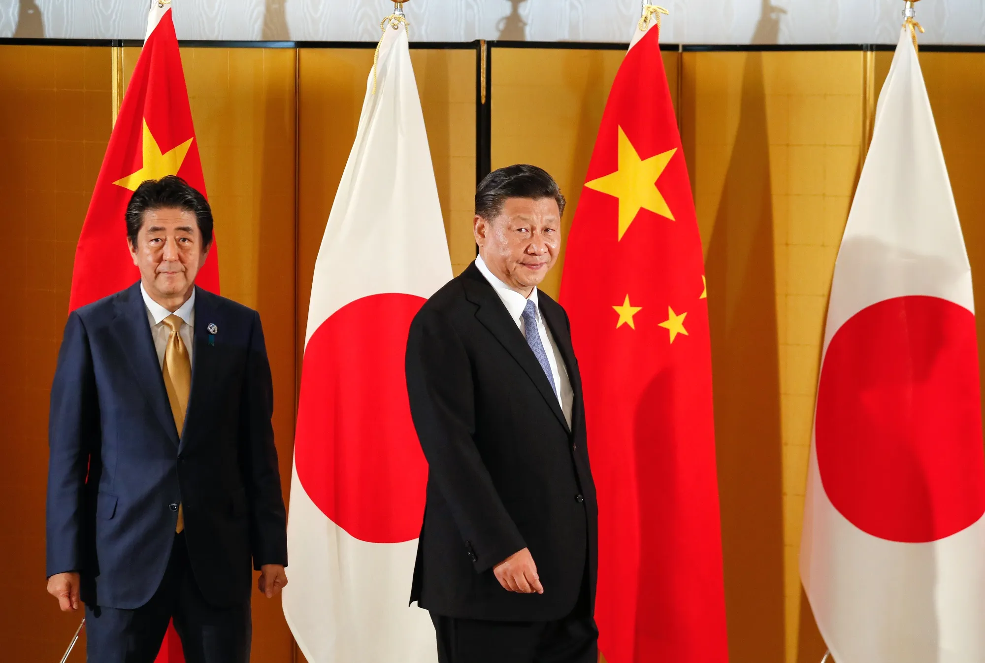Shinzo Abe, left, and Xi Jinping, meet at the G-20 summit in Osaka, Japan, in 2019.