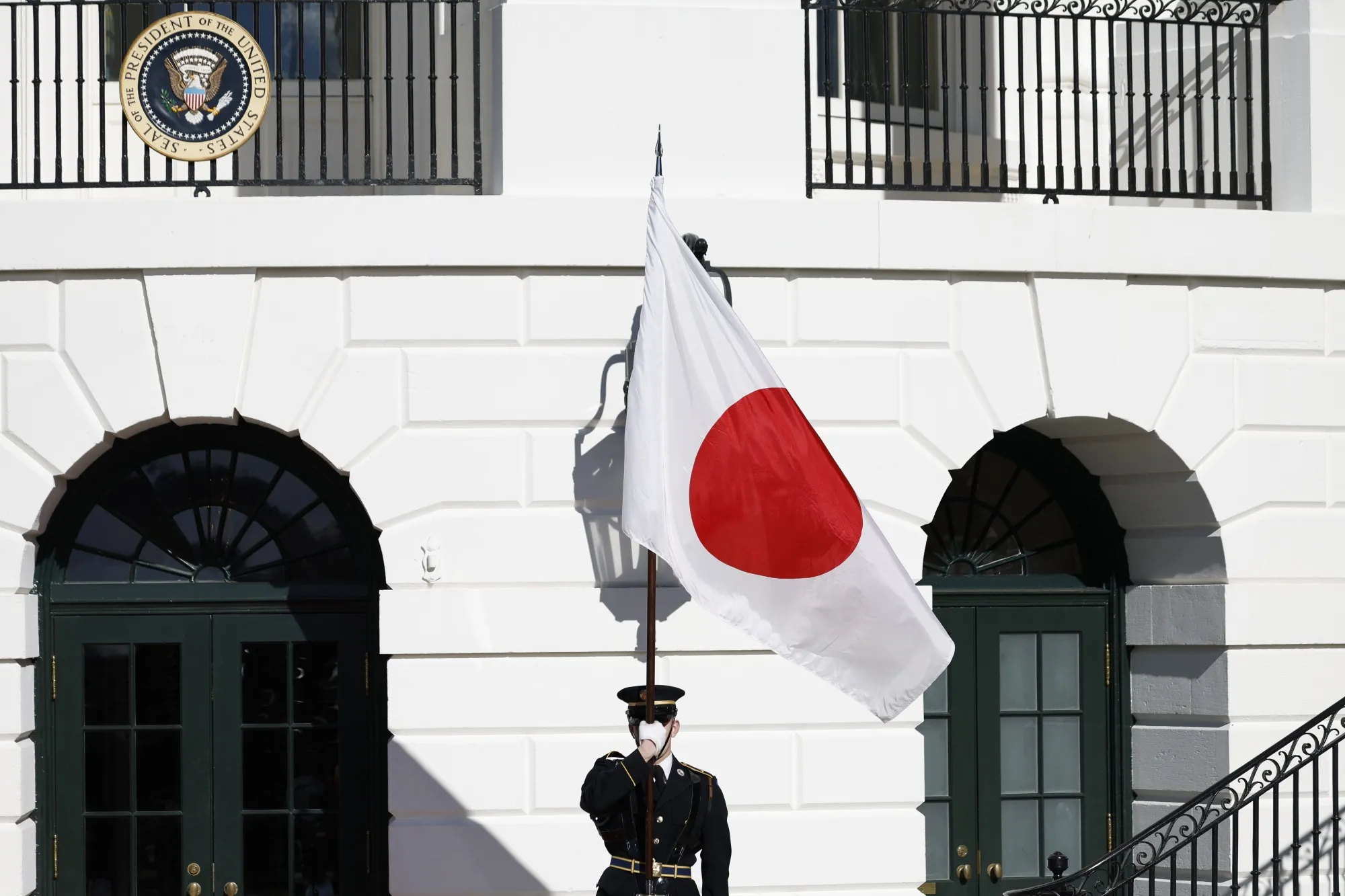A member of the honor guard holds a Japanese flag ahead of a visit by Japanese Prime Minister Fumio Kishida at the White House&nbsp;on Jan. 14.&nbsp;