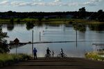 People look out at floodwaters from a closed road in the suburb of Pitt Town Bottoms in Sydney in march 2021.&nbsp;