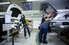 Employees install cable into a Mercedes-Benz GLC sports utility vehicles (SUV) on the assembly line at the luxury automaker's factory in Bremen, Germany, on Tuesday, Jan. 24, 2017. BMW lost its crown as the world's biggest luxury-car brand to Mercedes-Benz, ending its reign after more than a decade amid a cluttered lineup of aging models.