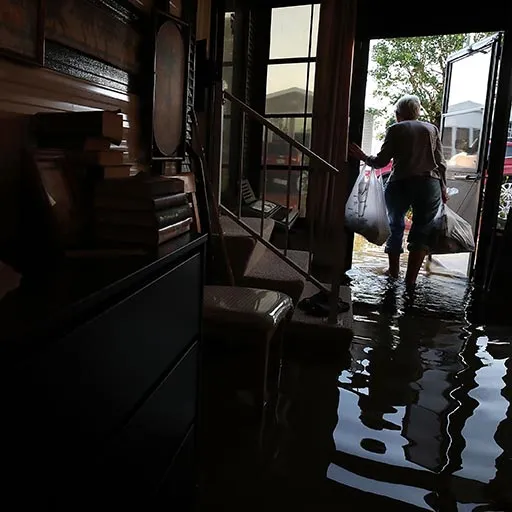 A resident of Bonita Springs, Fla., removes her belongings from her home on Sept. 12, 2017, after it was flooded by Hurricane Irma.