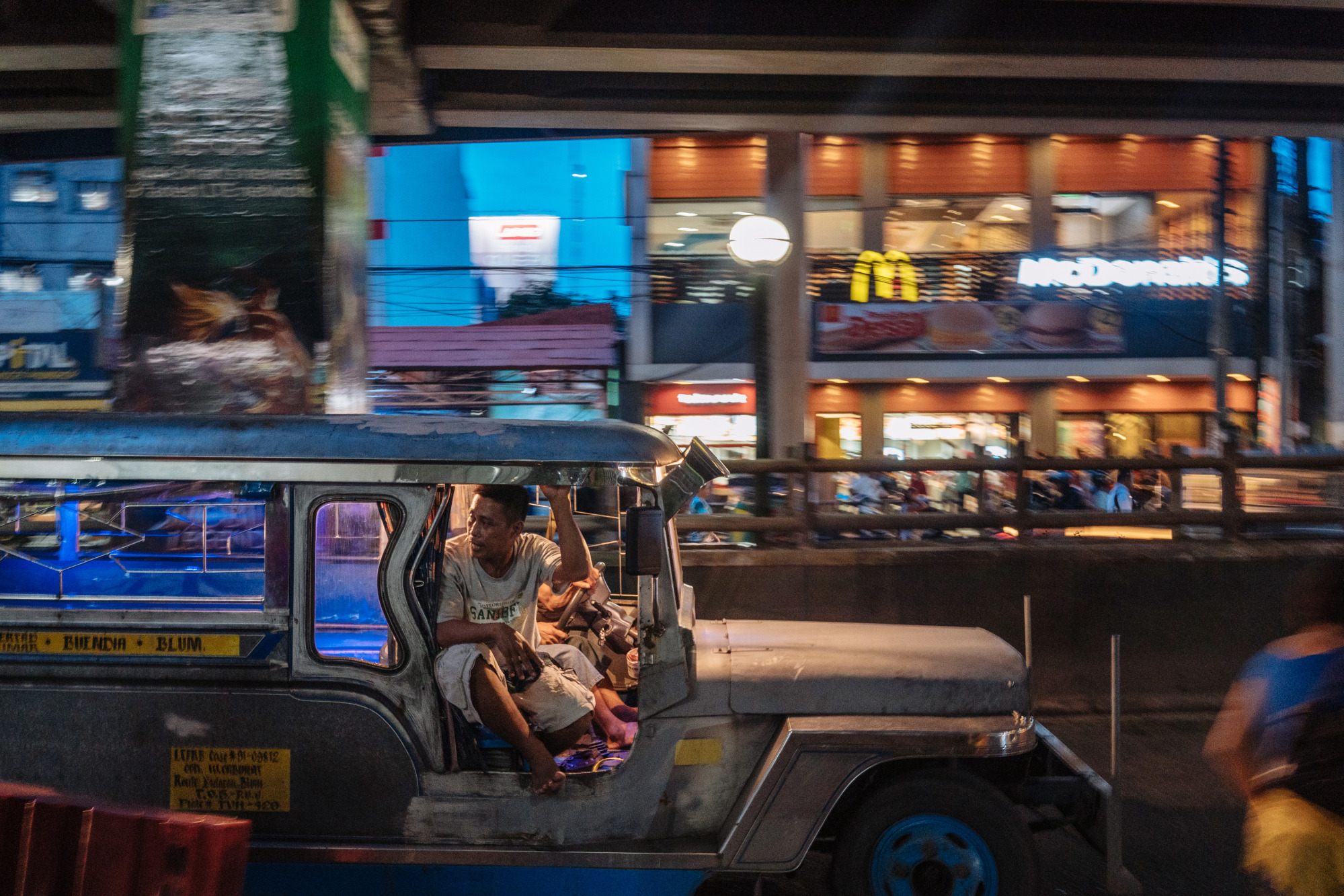 A jeepney travels along a road in Manila, Philippines.