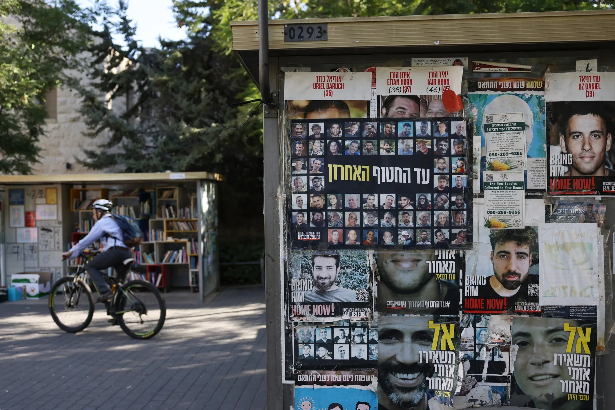 A notice board displays portaits of Israeli hostages, held by Hamas in the Gaza Strip,&nbsp;near a bus stop in Jerusalem.