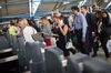 Commuters queue to exit a ticket barrier after their train arrives due to overrunning renovation works at London Waterloo railway station in London, U.K., on Tuesday, Aug. 29, 2017. The 800 million-pound ($1 billion) renovation at Waterloo, which opened four platforms mothballed since Channel Tunnel express trains switched to St. Pancras station and extended four more, aims to boost peak-time capacity by 30 percent.