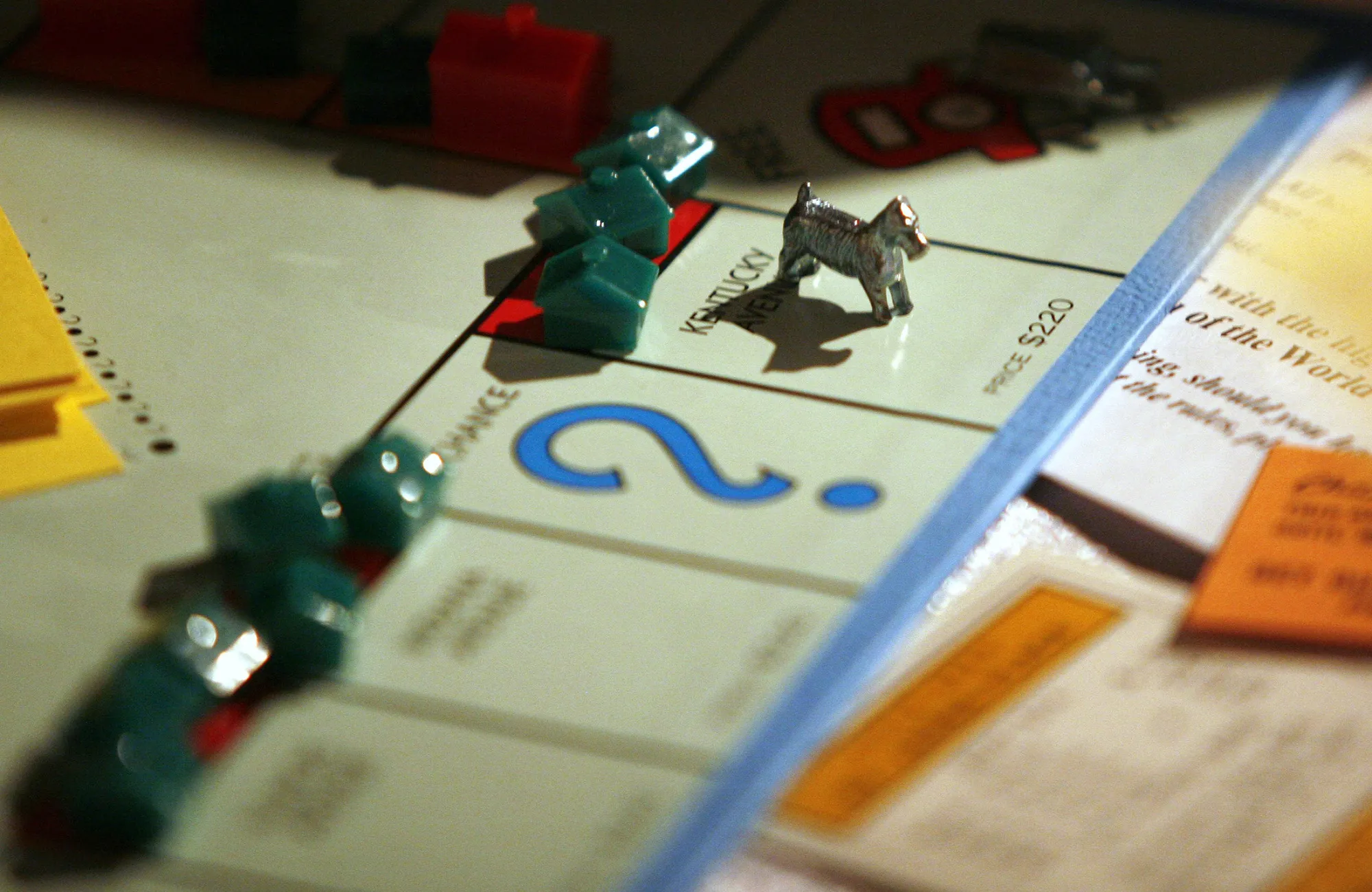 A game piece sits on the board game Monopoly, manufactured by Hasbro.
