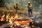 Firefighters mop up hot spots while battling the Oak Fire in the Jerseydale community of Mariposa County, Calif., on Monday, July 25, 2022. They are part of Task Force Rattlesnake, a program comprised of Cal Fire and California National Guard firefighters. (AP Photo/Noah Berger)