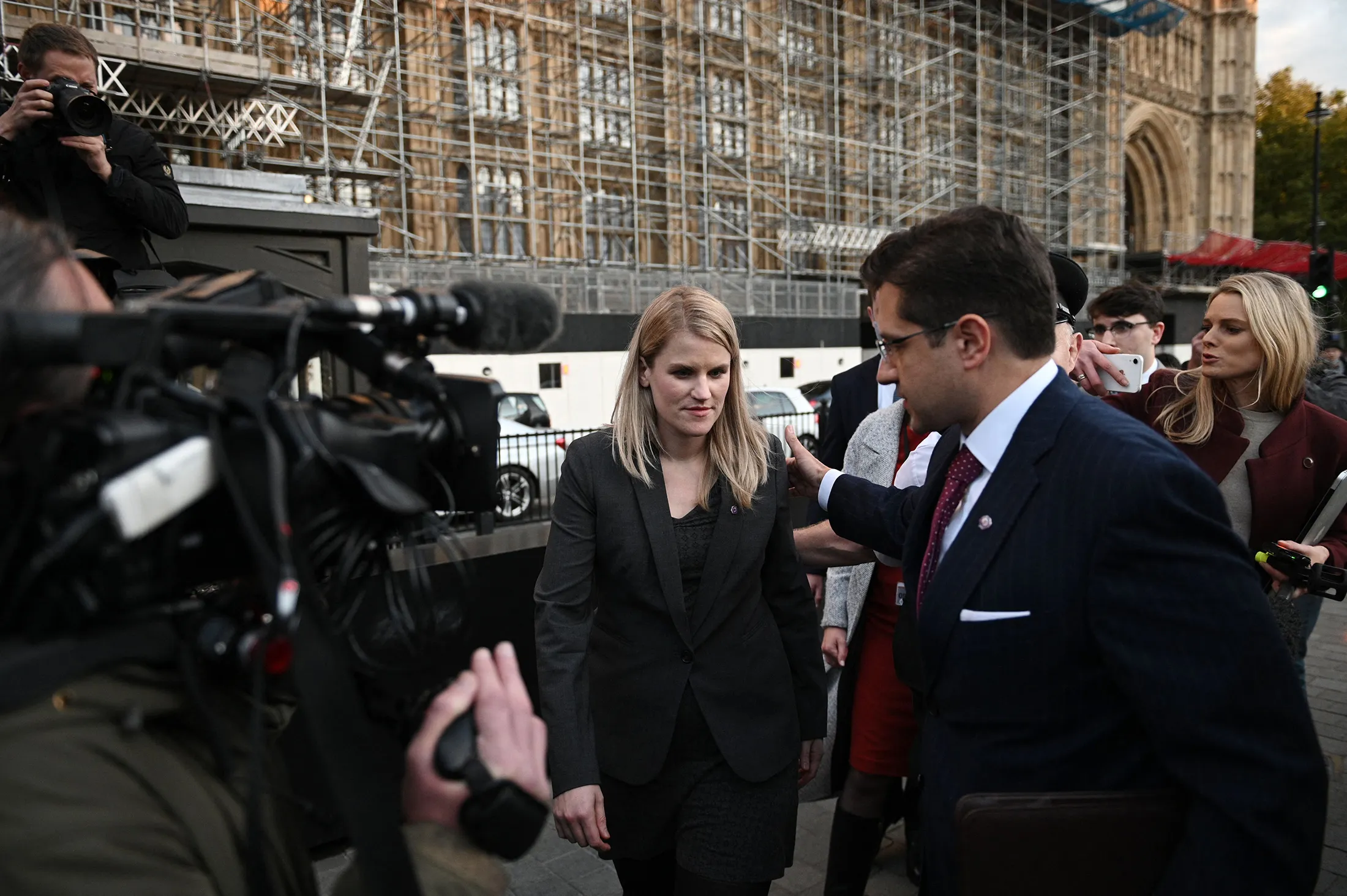 Frances Haugen, center, leaves the Houses of Parliament in central London on Oct. 25.